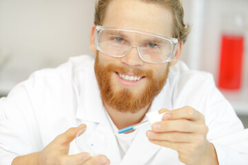 happy male lab worker smiling at camera © auremar
