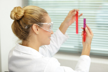 female tech works in chemical lab