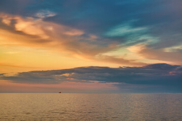 sunset over the sea with ship on horizon.  - 605886243