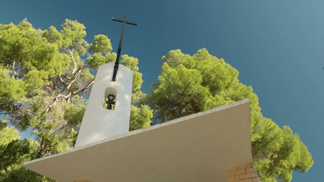 Cross and bell tower of the Ermita de San Pascual in Ibi, Alicante, Spain