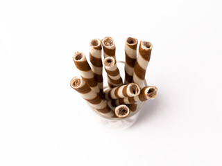 Wafer rolls with chocolate isolated on white background.