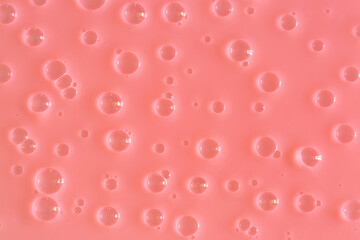 Bubble pink peachy background texture. Berry gel to cleanse the skin of the face and body. Spa treatments, skin care. Bath foam, detergent. Slime pink coral.