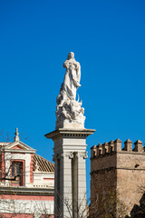 Fototapeta na wymiar Monument to the Immaculate Conception in Triunfo Square, historic center of Seville, Spain.