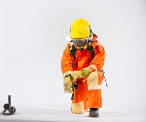 Obraz na płótnie Canvas With focused intent the professional firefighter sits in a kneeling position carefully sliding their gloved hand into place, ensuring a snug and secure fit.