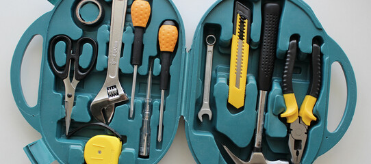 Opened plastic case with electrical tools kit on white detailed stock photo