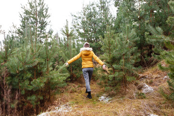 young woman in the middle of a coniferous forest alone
