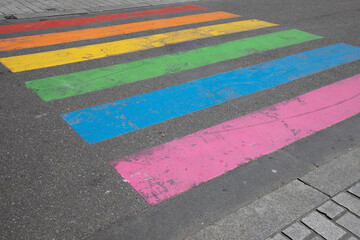 town street pedestrian pathway crossing paint in colors rainbow flag sign to sex discrimination concept of the LGBT+ community in city center