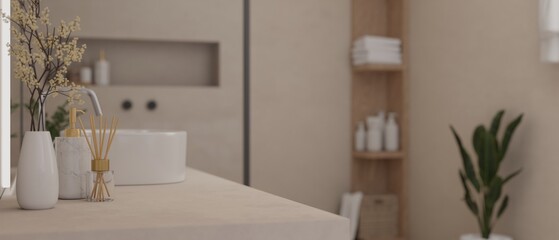 Close-up view of a modern bathroom vanity top with decor and a ceramic sink