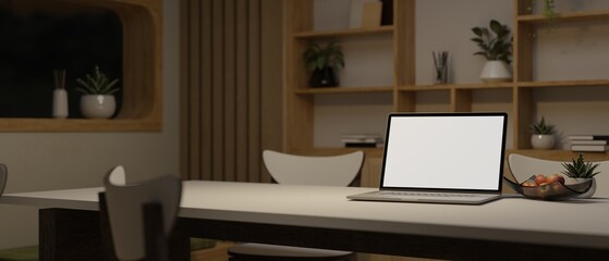 A laptop mockup on a dining table in a minimal cozy dining room. Home workspace