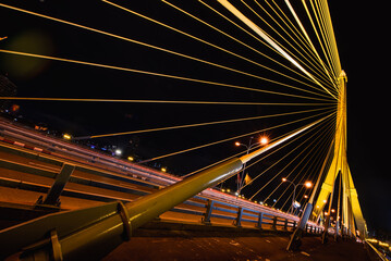 Obraz premium Long exposure night land scape at rama VIII bridge, the famous suspension bridge in Thailand , Bangkok, Thailand