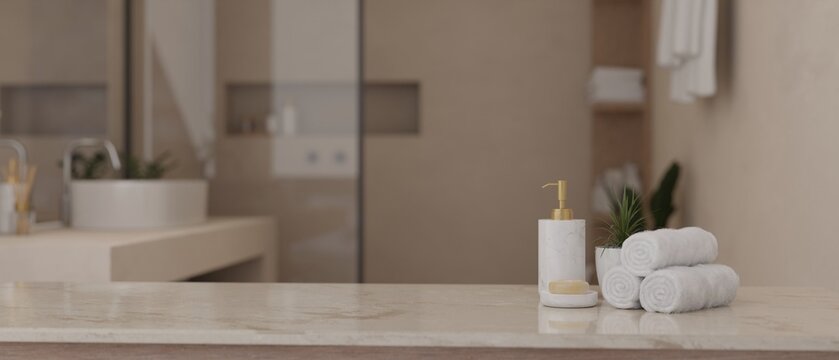 Copy space on a white marble tabletop in a modern luxury bathroom.