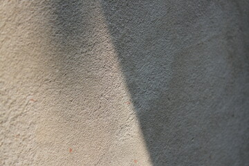 Fototapeta premium Cement and brick wall texture background, sun rays on the cement wall surface, smooth cement wall backdrop