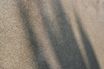 Cement and brick wall texture background, sun rays on the cement wall surface, smooth cement wall backdrop