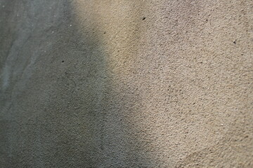 Sun shining on a cement wall background, grungy shiny wall surface, rusty cement wall backdrop