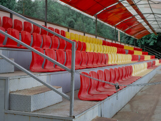 rows of seats for fans. closed. chain and lock at the entrance. there are no people