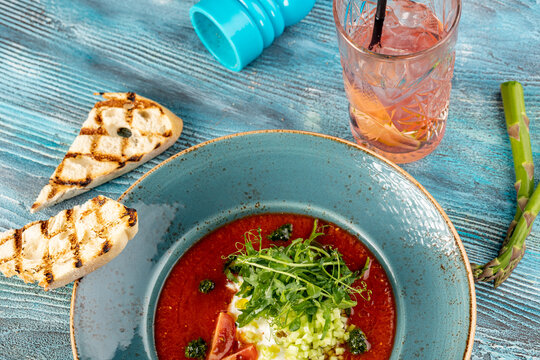 hot fresh tomato soup with pesto, vegitables and microgreens