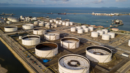 Aerial view oil storage tank farm and oil terminal, Tank farm storage chemical petroleum petrochemical refinery product at oil terminal, Business fuel and energy transport by tanker ship.