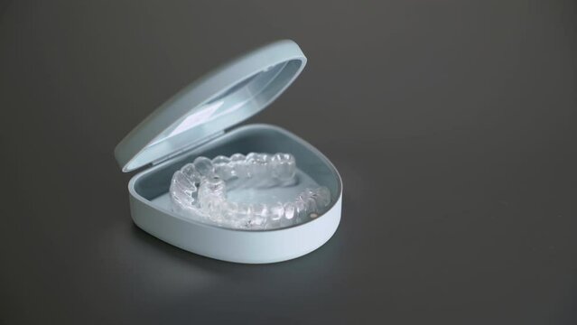 Dental aligner in box. Invisible orthodontic cosmetic brackets.
