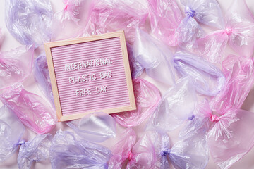 Plastic free environment protection concept, International Plastic Bag Free Day words on felt board. Empty used plastic bags, Aesthetic top view flat lay, eco trend to reduce disposable plastic