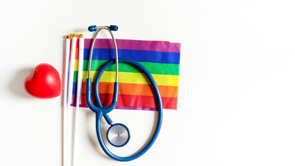 stethoscope on lgbtq rainbow flags pride symbol and red heart isolated on white background with...