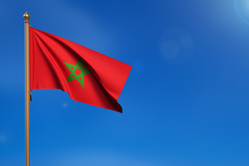 Morocco. Flag blown by the wind with blue sky in the background.