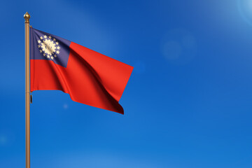 Myanmar - Burma. Flag blown by the wind with blue sky in the background.