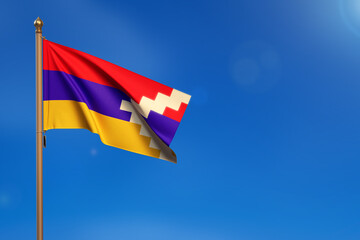Nagorno-Karabakh Republic. Flag blown by the wind with blue sky in the background.