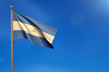 Nicaragua. Flag blown by the wind with blue sky in the background.