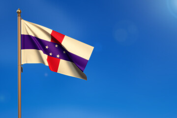 Netherlands Antilles. Flag blown by the wind with blue sky in the background.