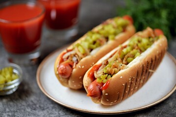 Homemade hot dogs with fried onions, pickled cucumbers tomato sauce and mustard.