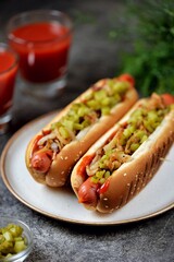 Homemade hot dogs with fried onions, pickled cucumbers tomato sauce and mustard