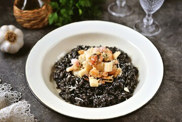 Healthy black risotto with cuttlefish ink and seafood.