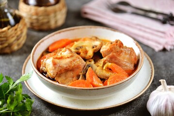 Braised rabbit with carrots, mushrooms, onions and smoked paprika.