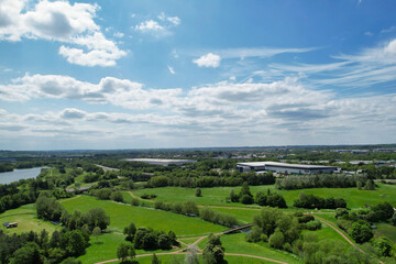 Fototapeta na wymiar High Angle Footage of Caldecotte Lake which is Located at Milton Keynes City of England Great Britain, The Footage Was Captured with Drone's Camera on 21-5-23 During Warm Sunny Day over UK.