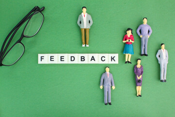 miniature people and glasses with the word feedback or response. customer review concept. Customer services. 
