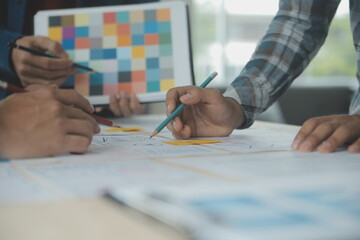 Close up ux developer and ui designer brainstorming about mobile app interface wireframe design on...