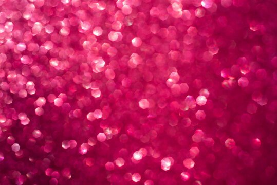 Abstract bokeh pink shiny blurred background with place for your text and design.