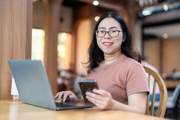 Happy of asian freelance people business female read writing message on smartphone casual working with laptop computer and coffee cup in at the cafe, Business Lifestyle communication concept