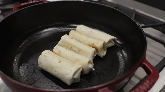Burritos cooking in a slow cooker, top view, Mexican food at home.