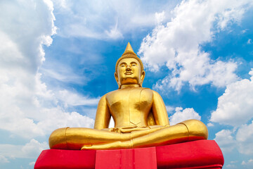 big golden buddha statue with blue sky background, Buddhist believe and merit