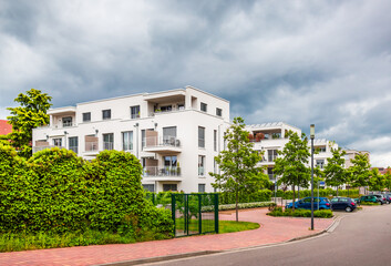 Fototapeta na wymiar Suburban residential street with modern houses and green park