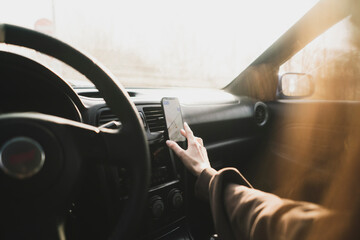 Naklejka premium car driver touch smartphone using navigator
