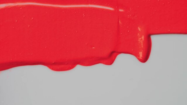 Red lipstick texture. Spatula or small stopping knife. Abstract background, art. Mixing colors concept.
