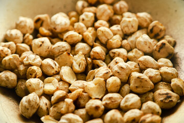 Kemiri or candlenut are fried in a frying pan before finally being mashed and the oil is squeezed out