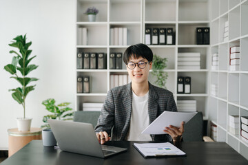 Young business man executive manager looking at laptop watching online webinar training or having virtual meeting video conference doing market research working in office...