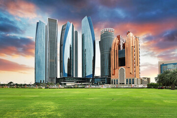 Skyscrapers in Abu Dhabi at dramatic sunset, United Arab Emirates