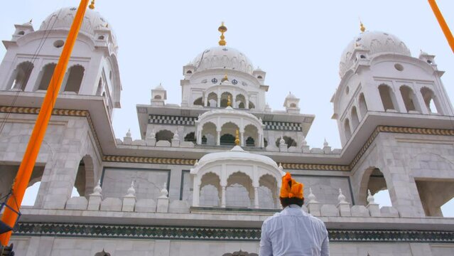 Pushkar Gurudwara - a religious place for worship for Sikhs - offering prayers  religious faith and belief. A young guy wearing an orange head scarf at the Gurdwara Sahib in Pushkar - Sikhism  a re...