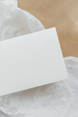 White business card mockup on beige background. Wedding invitation mockup. Name car, place card mock up