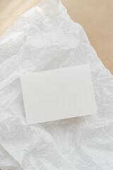 White business card mockup on beige background. Wedding invitation mockup. Name car, place card mock up