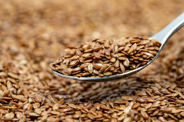 Flax seeds background or texture. Flaxseed or linseed in a spoon. cereals healthy food. Close up